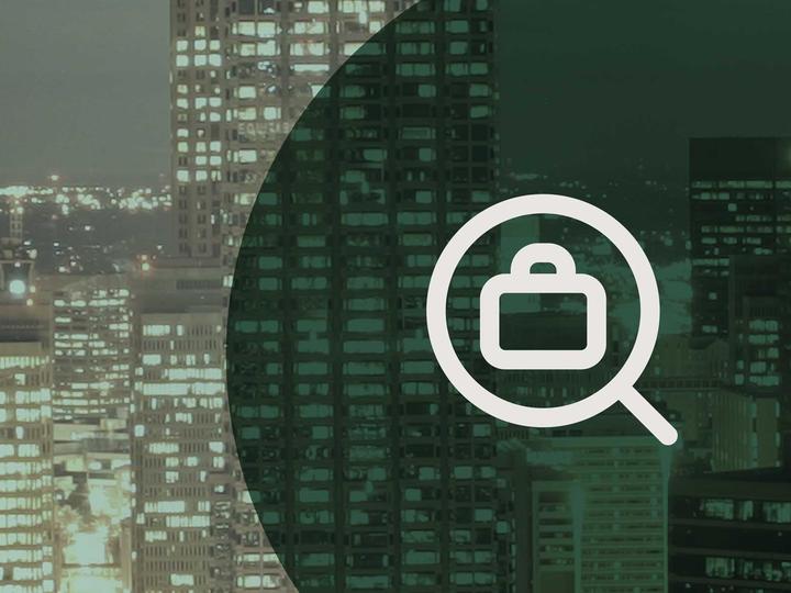 Icon of a briefcase in a magnifying glass in front of a photo of downtown Atlanta.