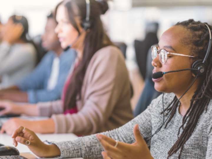 Photo of customer service workers wearing headsets.