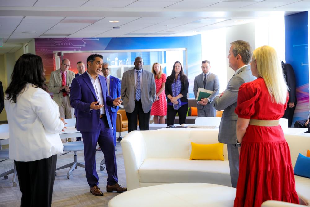 Georgia CIO and GTA executive director Shawnzia Thomas and Georgia chief digital and AI officer Nikhil Deshpande (left) speak with Governor Brian Kemp and First Lady Marty Kemp (right) at the ribbon cutting and grand opening.