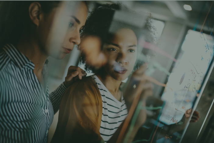 Image of two people looking at a screen